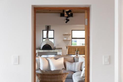 a living room with a couch with pillows at Bayview Bliss at Springerbaai in Mossel Bay