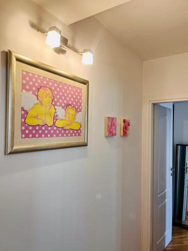 a painting of two rubber ducks on a wall at Sea View Beachfront Apartment Maslina in Omiš
