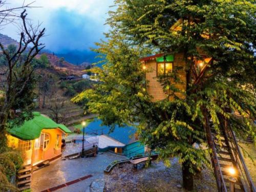 an aerial view of a house next to a lake at Zostel Plus Mussoorie- Kempty in Mussoorie