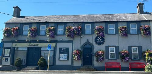 a building with flowers on the side of it at Madelines Accommodation in Tinahely