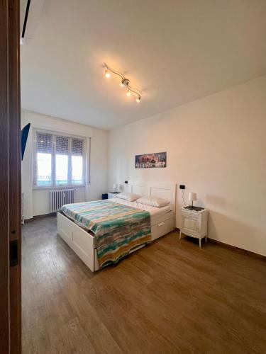 a large bedroom with a bed and a window at Chicco & Didi in Rapallo