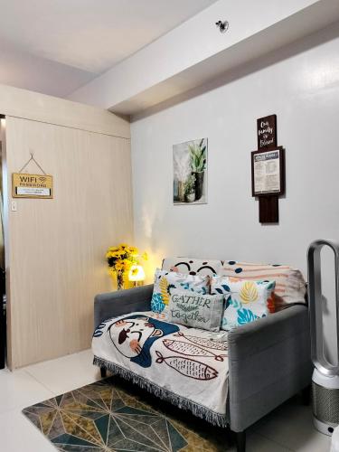 a bedroom with a bed and a tv in it at CONDO Staycation Sea Residence MOA-Kharen in Manila