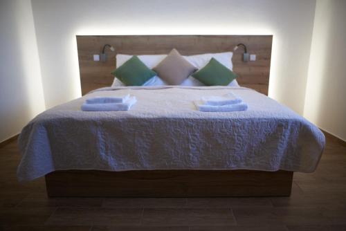 a bed with a blue blanket and pillows on it at Penzion 666 Slavonice in Slavonice