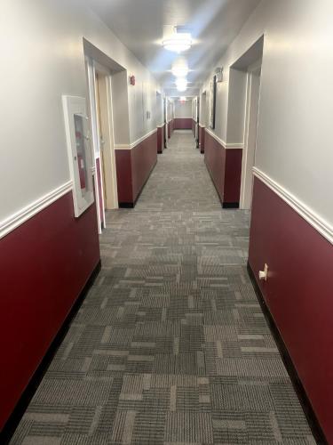 an empty hallway in a hospital room with a long aisle at Ramada by Wyndham Florenceville in Florenceville