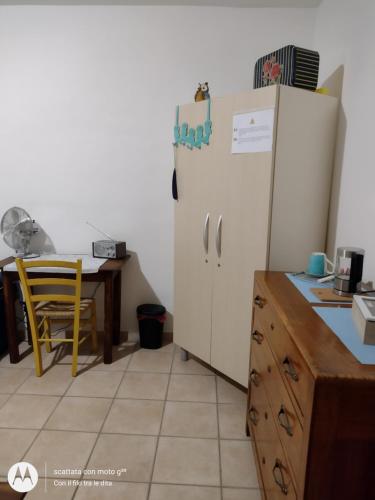 a kitchen with a white refrigerator and a table at Con il filo tra le dita in Ronchi dei Legionari