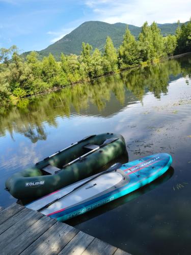 two kayaks are sitting on the water next to a dock at Chata Párničkovo in Párnica