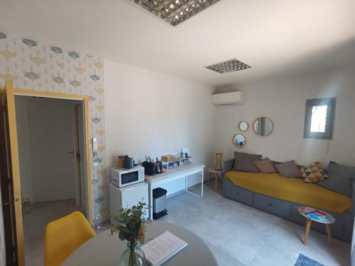 una sala de estar con una cama y una mesa en La Chambre du Saunei, en Castelnau-de-Guers