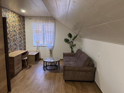 a living room with a couch and a table at Penzion 666 Slavonice in Slavonice
