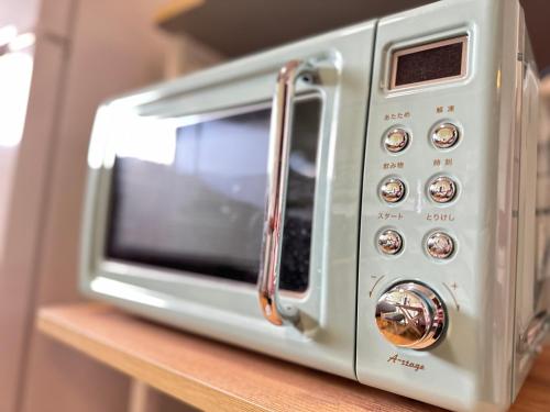 a silver toaster oven sitting on top of a counter at newisland in Tadotsu