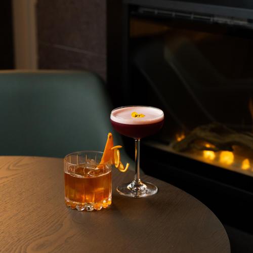 a drink sitting on a table next to a glass at Brooks Hotel in Dublin