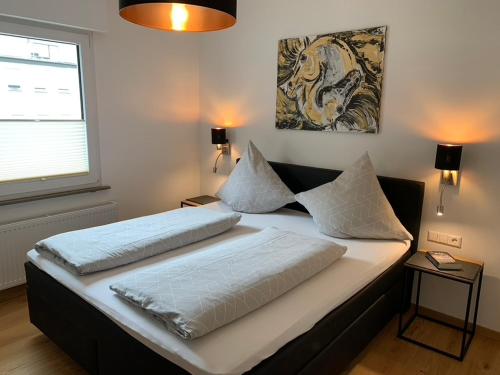 a bed with two pillows on it in a bedroom at Ferienwohnungen Rees in Briedel