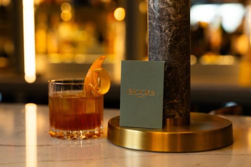 a drink on a table next to a candle at Brooks Hotel in Dublin