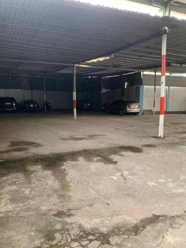 a parking lot with cars parked in a garage at Nhà Nghỉ Quỳnh Hương - Quynh Huong Hostel in Long Thành