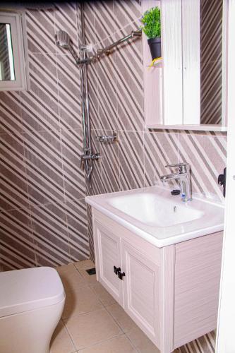 a bathroom with a sink and a toilet at Kindow Appart in Pointe-Noire