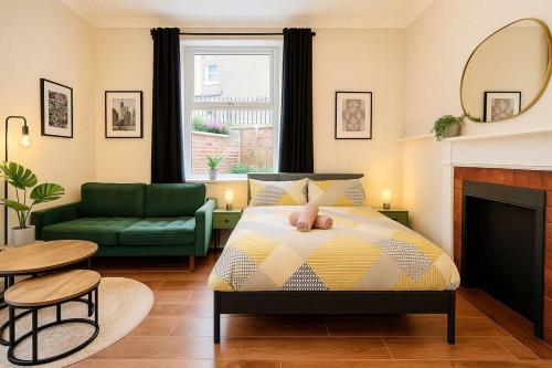 a bedroom with a bed and a living room at Central Studio Apartment for 2 in Cardiff