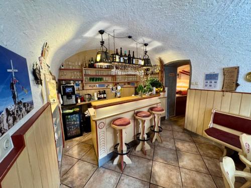 a bar with two stools at a counter at Hotel Restaurant Gasthof Michal in Gundersheim