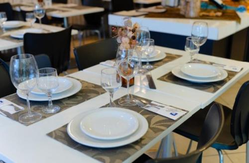 a table with plates and wine glasses on it at Camaçari Plaza Hotel in Camaçari