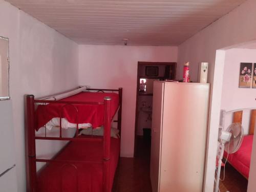 a room with a red refrigerator and a red table at Cabaña Piedra Blanca in San Rafael