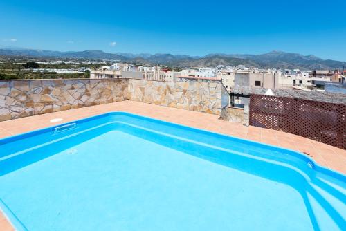 a swimming pool on the roof of a building at Hotel Toboso Chaparil in Nerja