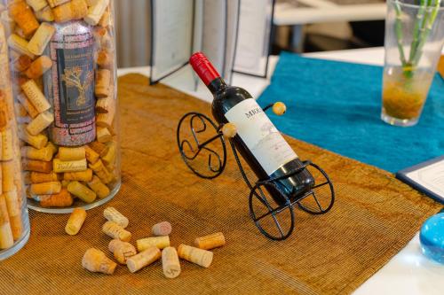 a bottle of wine sitting on top of a table at Camaçari Plaza Hotel in Camaçari