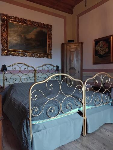 a bed in a room with a picture on the wall at All'Antico Convento in Cannero Riviera