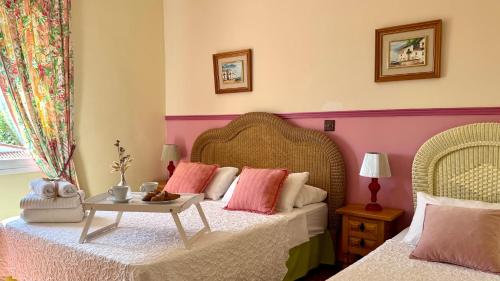 a bedroom with two beds and a table at El Cid Country Club in Benidoleig