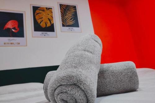 a person with their feet up on a bed at BR Parklands Hotel in Klang