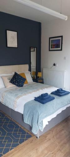 a bedroom with a bed with blue towels on it at spacious self-contained accommodation 135 cantebury road Herne bay CT6 5RZ in Kent