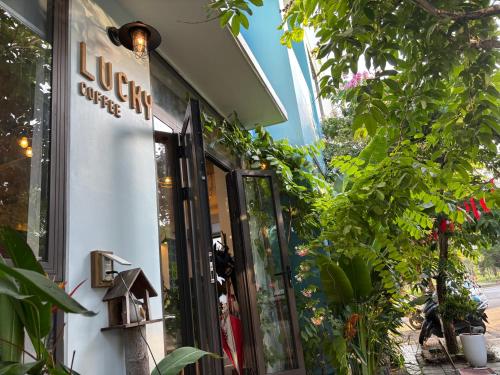 a store with a sign on the side of a building at Lucky coffee & homestay in Thôn Trường Giang