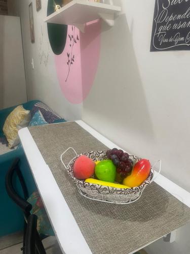 a bowl of fruit sitting on a table at Kitnet Adorável na sedede Aracruz ES 1KM do centro individual wifi cozinha equipada in Aracruz