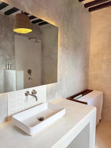 a bathroom with a white sink and a mirror at Star House 3 in Shela