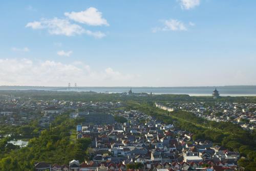 an aerial view of a city with the water at Aloft Surabaya Pakuwon City in Surabaya