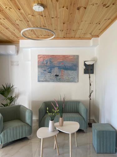 a living room with two couches and a table at Rastoni Apartments Skiathos in Troulos