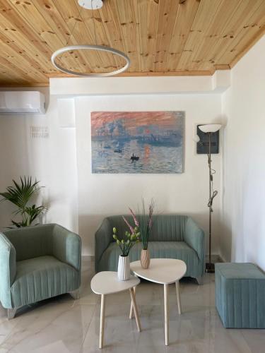 a living room with two couches and a table at Rastoni Apartments Skiathos in Troulos