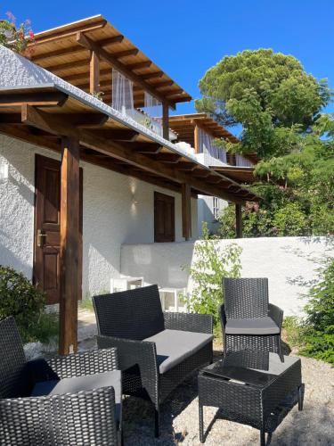 a group of chairs and tables on a patio at Rastoni Apartments Skiathos in Troulos