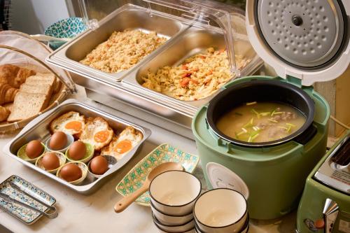 a counter top with some food and a pot of soup at Pran At Kumuang Boutique House in Chiang Mai