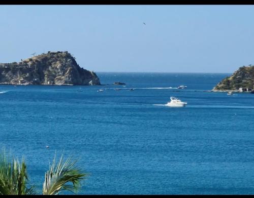 a boat in the middle of a large body of water at ARAWAK 601 Vista al Mar in Rodadero