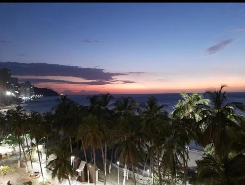 a view of a beach with palm trees and the ocean at ARAWAK 601 Vista al Mar in Rodadero