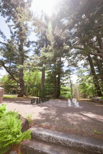 a park with a bunch of trees and a brick courtyard at Stonehurst Manor Breakfast & Dinner Included in North Conway