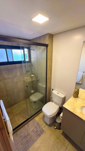 a bathroom with a toilet and a glass shower at Family apartment in Carmelitas in Asuncion