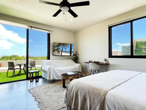 a bedroom with two beds and a large window at Private Jacuzzi, Golf Getaway, sunrise view in Puerto Aventuras