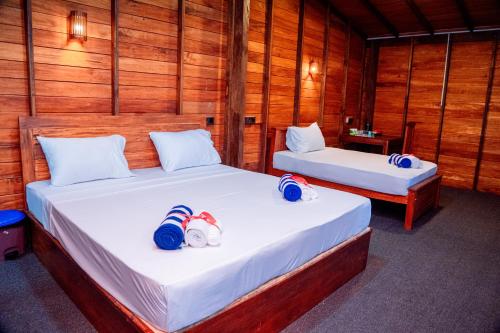 Postel nebo postele na pokoji v ubytování Golden Beach Hotel & Restaurant