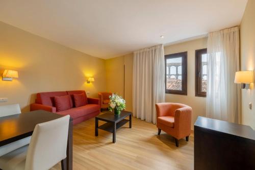 a living room with a couch and a table at Eurostars Plaza Acueducto in Segovia