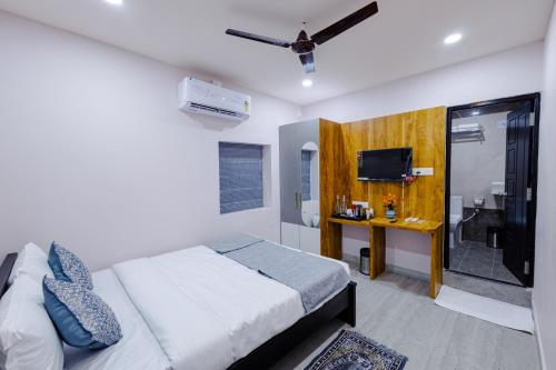 a bedroom with a bed and a television in it at Bestaay - A Boutique Hotel in Bhubaneshwar