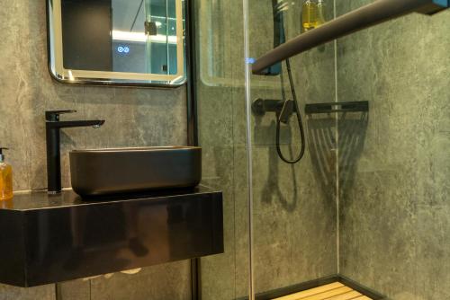 a bathroom with a sink and a shower at Skårungen - Hotel, Cabins and Camping in Kabelvåg