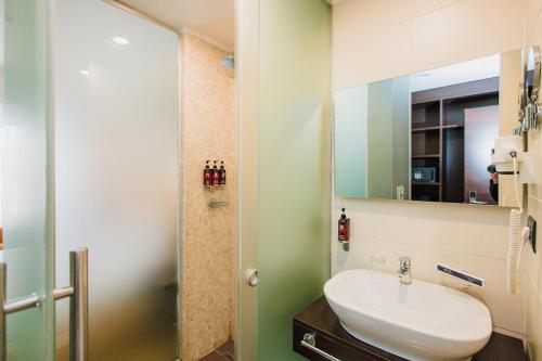 a bathroom with a sink and a mirror at Comfort Hotel Astana in Astana