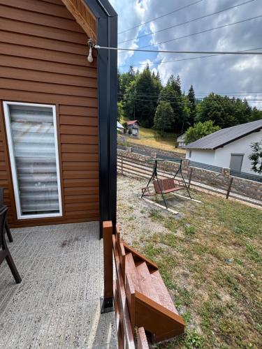 a patio with a bench on the side of a house at Villa in Rugovë, Kosovo in Lekaj