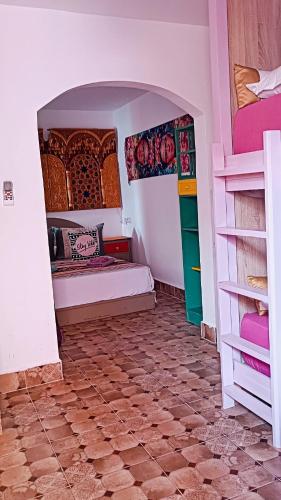 a room with two beds and a tiled floor at Riad SULTANA lateral seaview in Saidia 