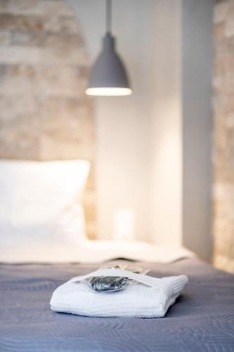 a white towel sitting on top of a bed at Luxury studio Thomas & Irini in Kos Town