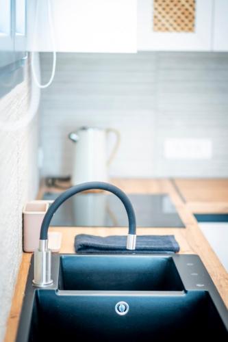 a kitchen sink with a faucet on a counter at Luxury studio Thomas & Irini in Kos Town